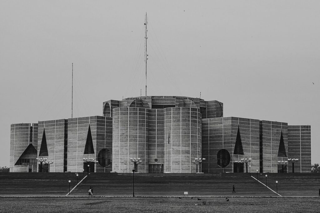Stunning black and white image of National Parliament House in Bangladesh, illustrating modernist architecture.