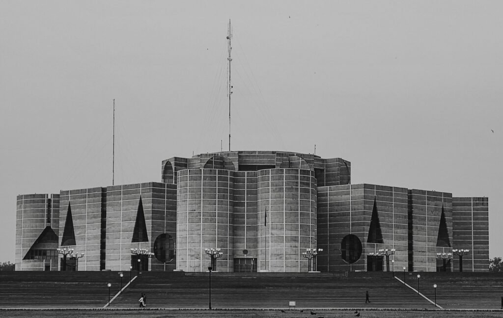 Stunning black and white image of National Parliament House in Bangladesh, illustrating modernist architecture.